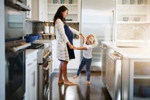 Mom and child dancing in kitchen