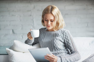 Woman relaxing on her Tablet